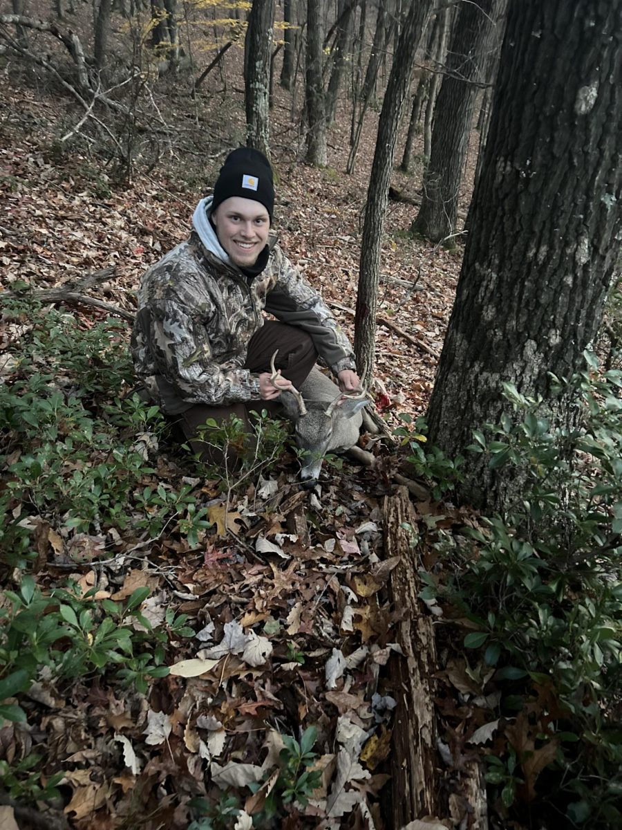 Isaac Shepler poses with a deer on the first day of bow season. 