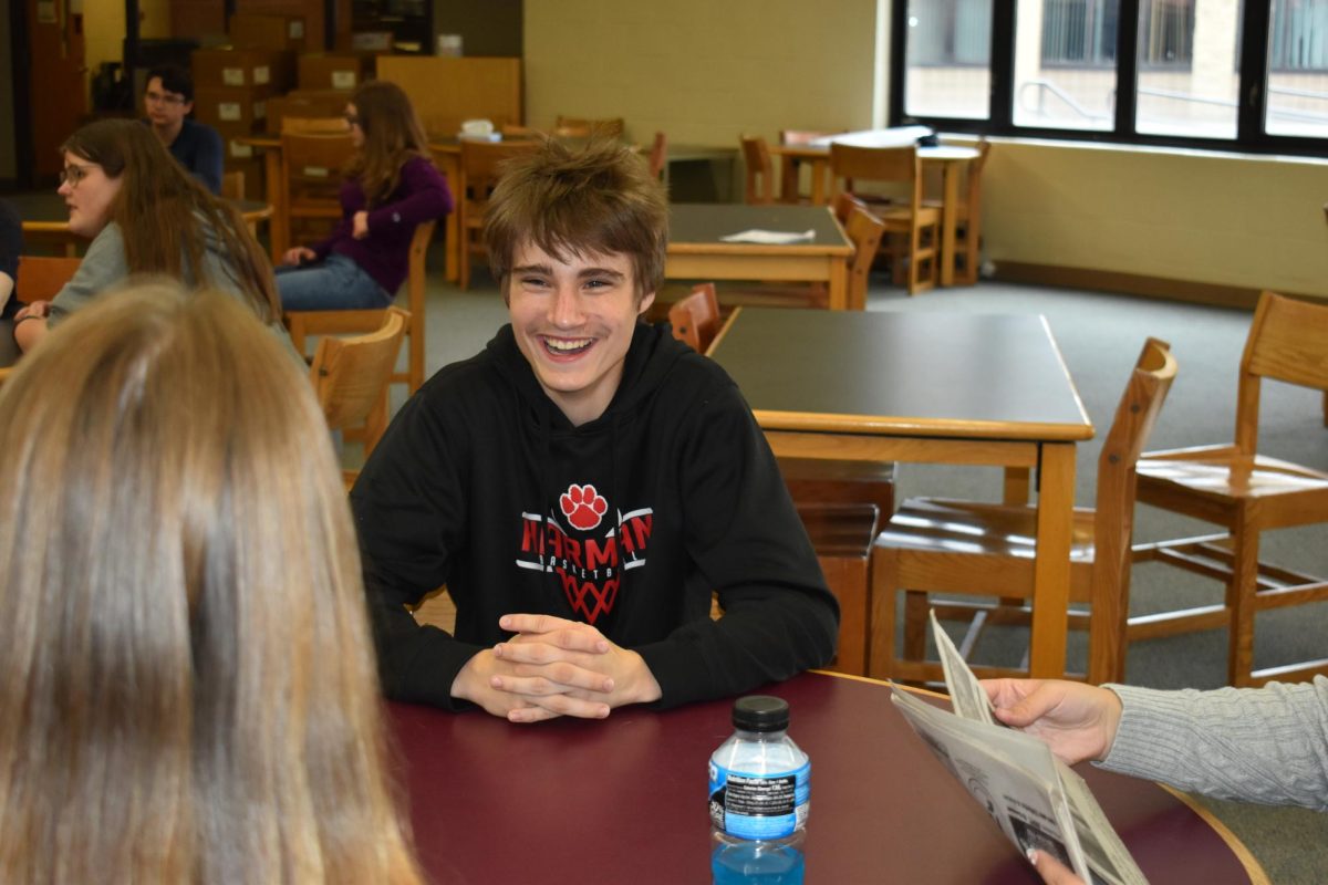 Harman student smiles while conversing with a Student Government member, Caroline L. 