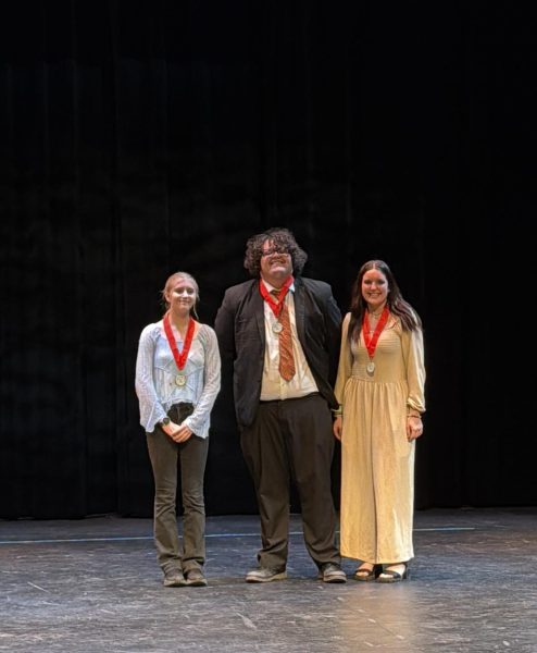 Jayla Reams, right, stands with other winners in competition. Reams tied for first in the speech competition.